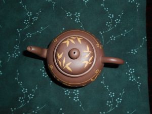 Round teapot with clay decoration